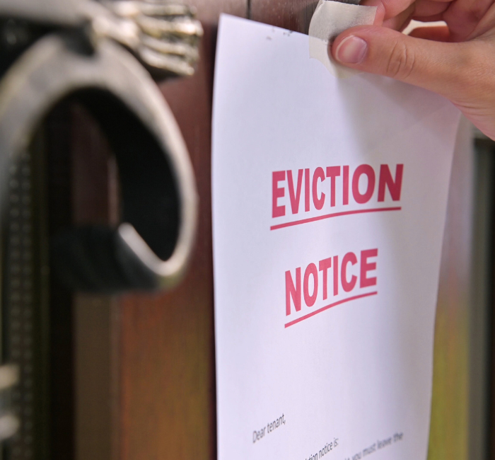 eviction notice being put on the door to a property after landlord tenant dispute