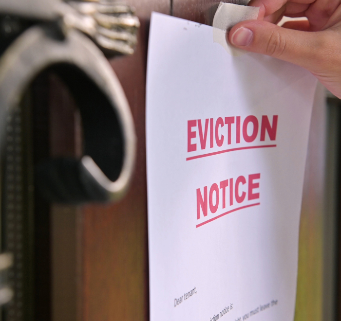 eviction notice being put on the door to a property after landlord tenant dispute