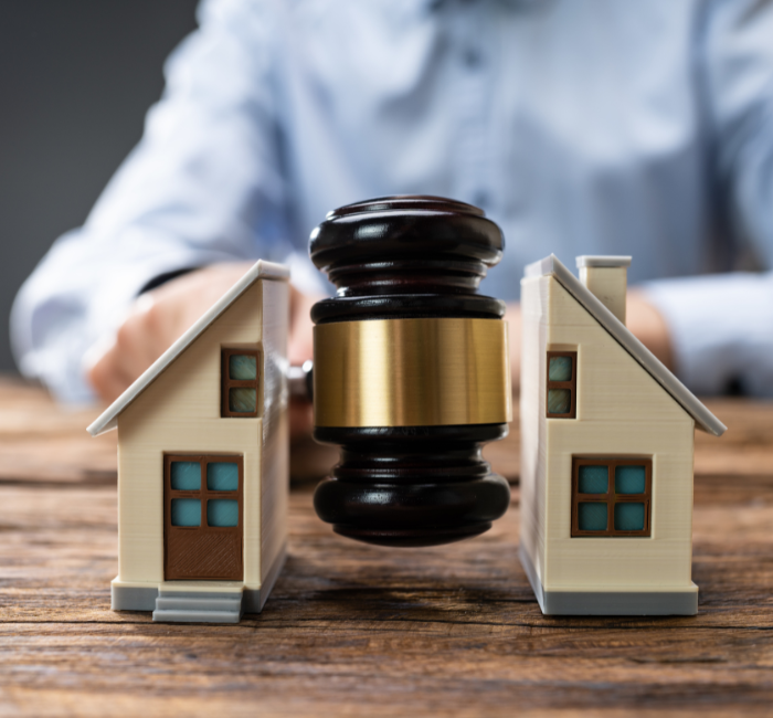 Image of a house being split in half by a judge's gavel