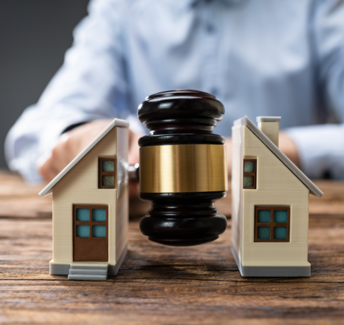 Image of a house being split in half by a judge's gavel